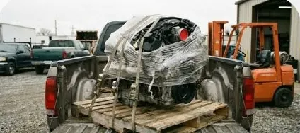 Engine strapped to a pallet in a pickup truck for delivery