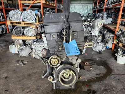 Used Acura Integra 1.8L B18B1 engine in front of engine racks